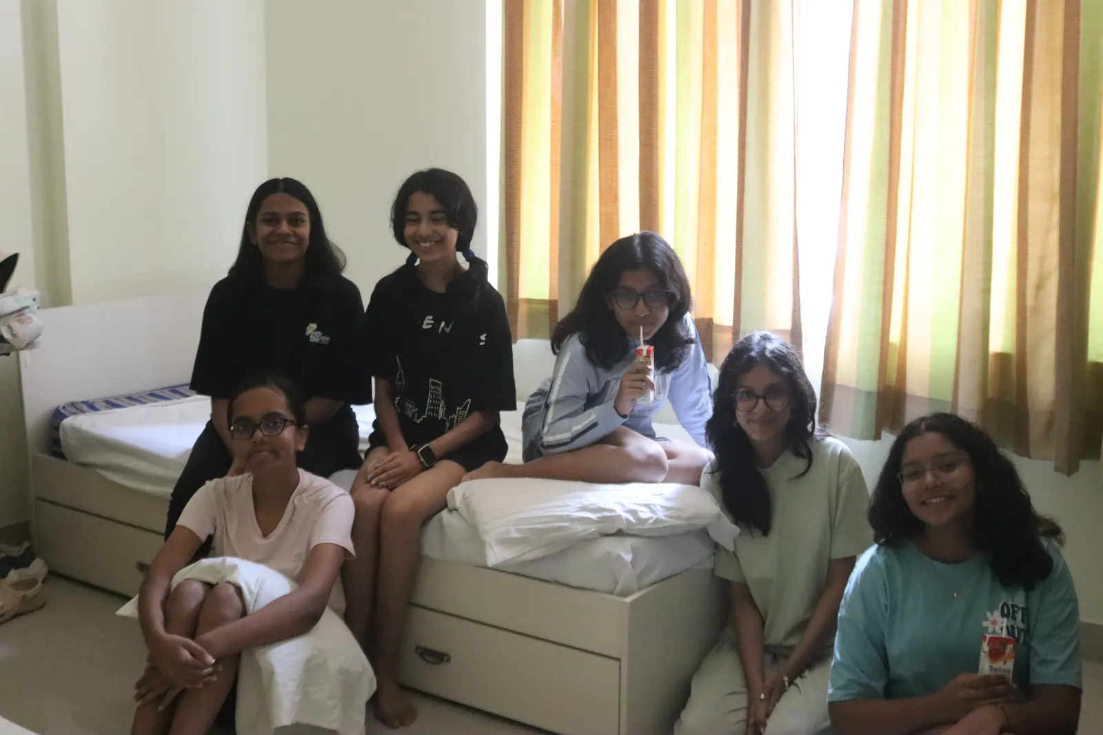 Six GenWise students hanging out in their dorm room